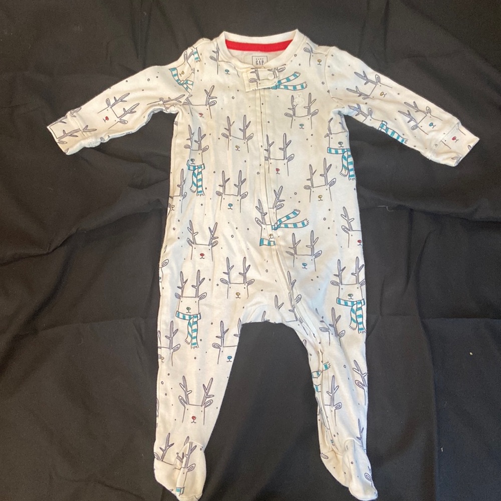 3 to 6 month long sleeve zip up onesie with repeating reindeer pattern